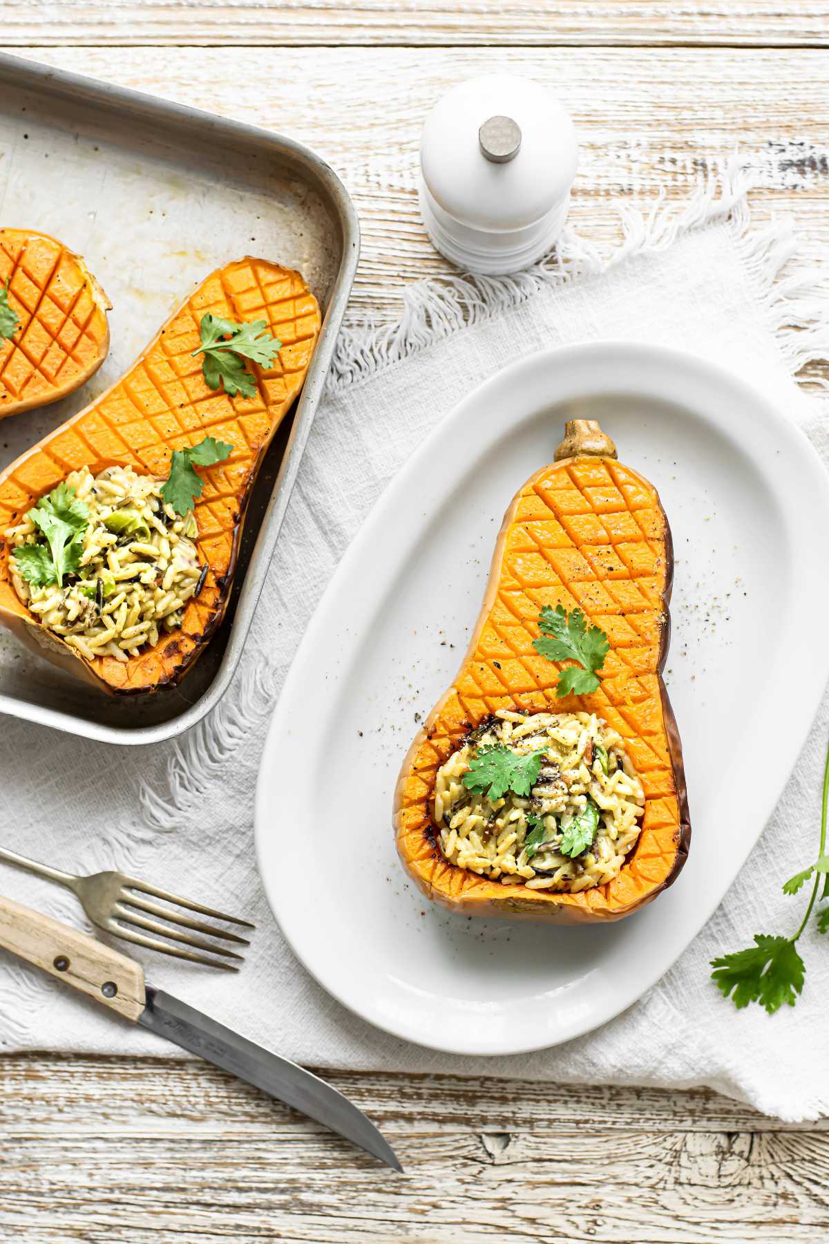 Butternut squash stuffed with rice on white plate